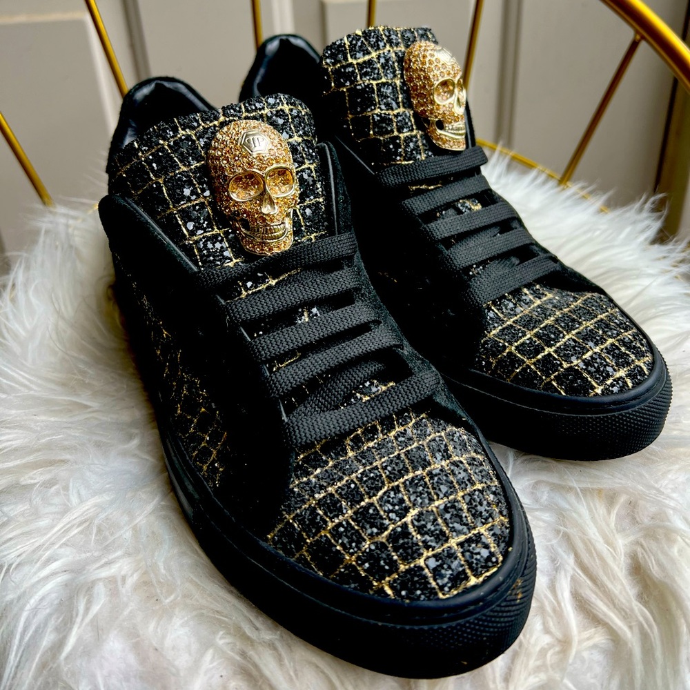 Philip Plein glittery black and gold skull sneakers.